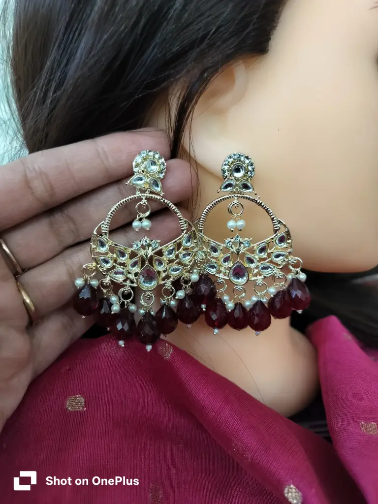 gold-plated kundan & maroon crystal beads dangle chandbali earrings. 