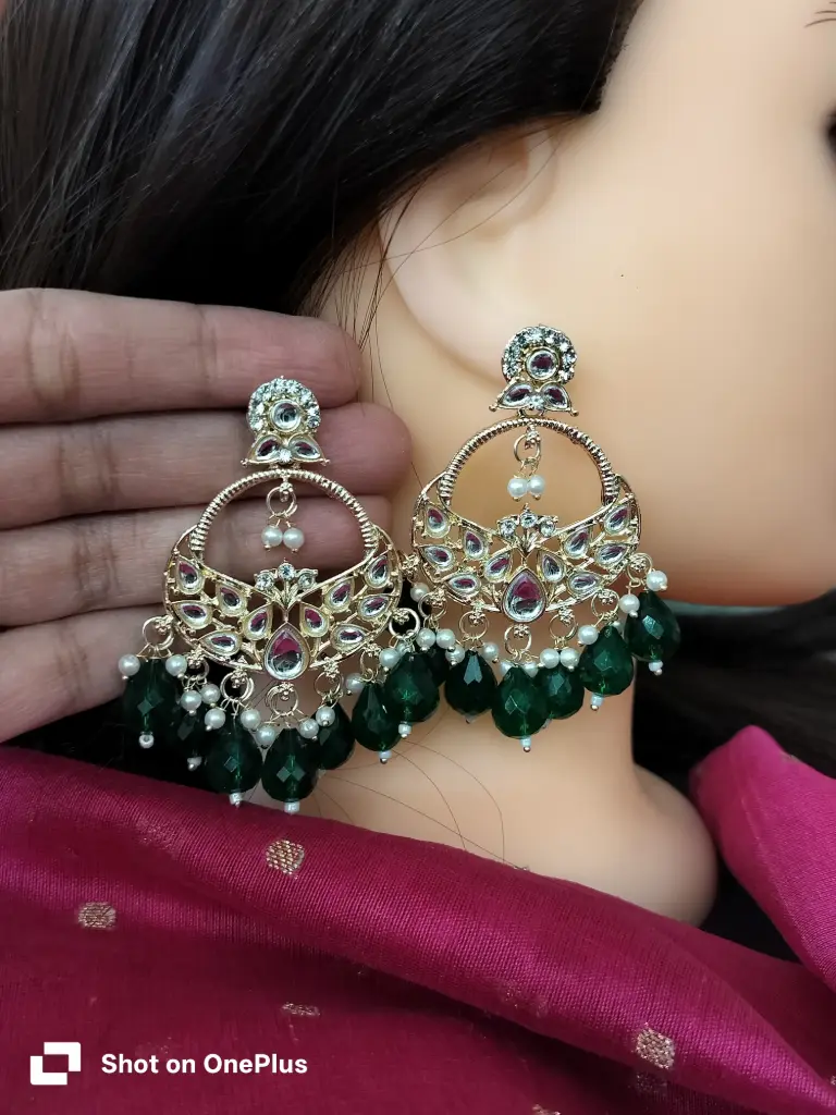 gold-plated kundan chandbali earrings with dark green crystal drops and pearls. 